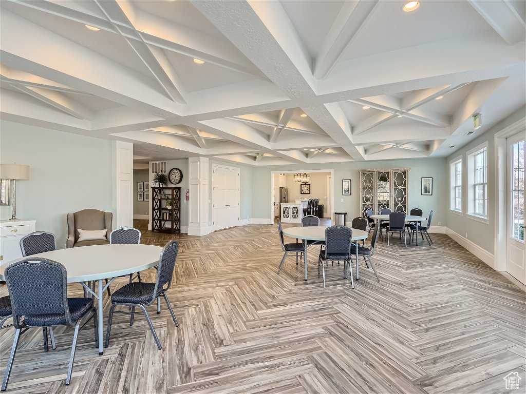 Dining space featuring coffered ceiling and beam ceiling