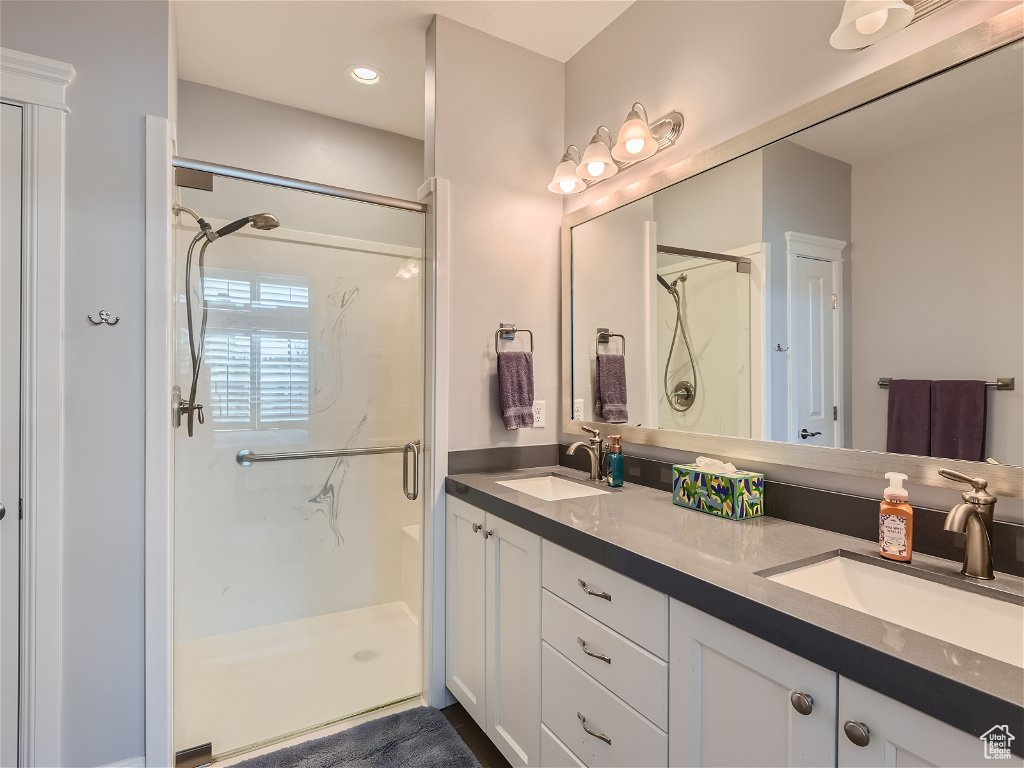 Bathroom with an enclosed shower and double sink vanity