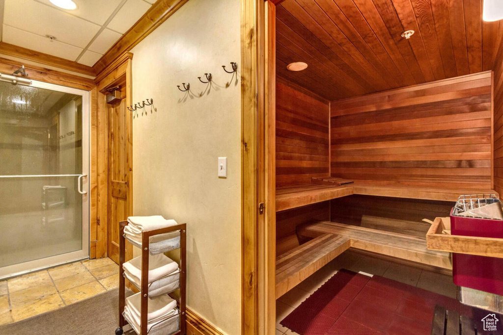 View of sauna / steam room featuring wood walls and tile floors