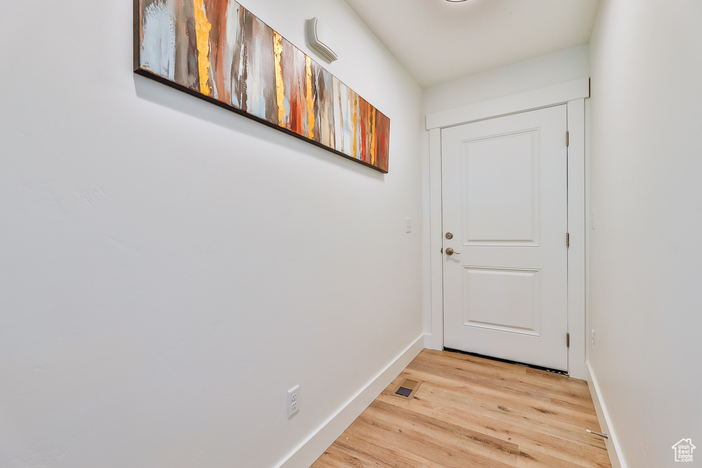 Doorway to outside with light hardwood / wood-style flooring