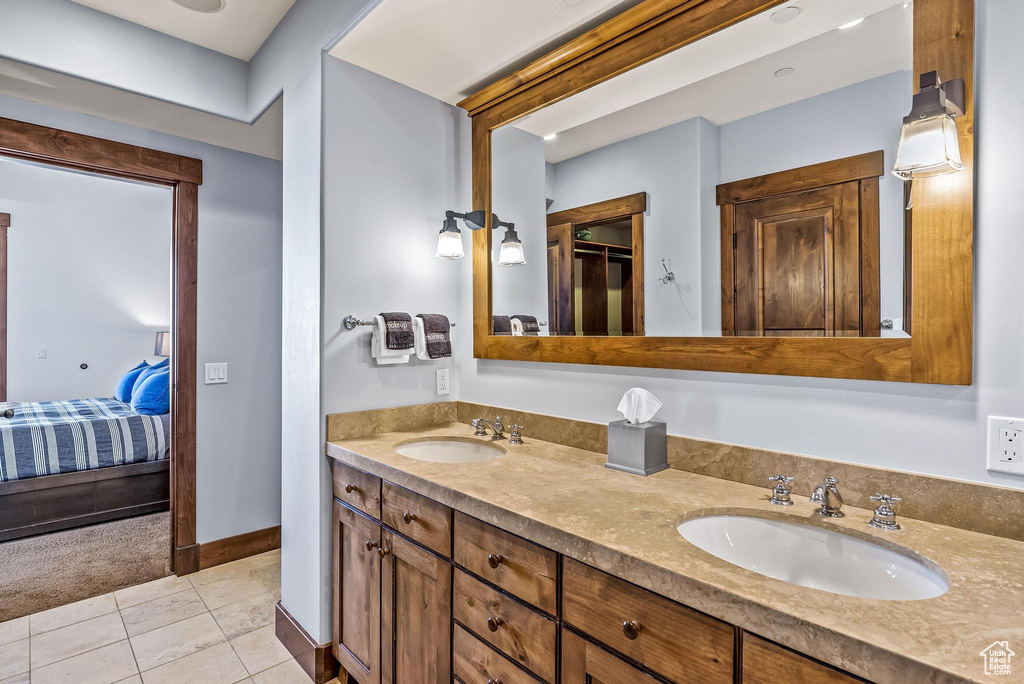 Bathroom with double sink vanity and tile floors
