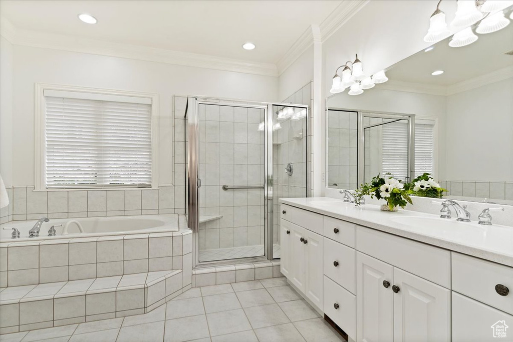 Bathroom featuring ornamental molding, oversized vanity, double sink, and tile flooring
