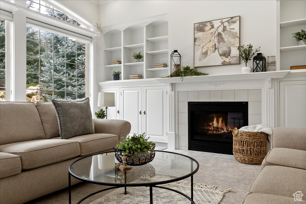 Interior space featuring a tile fireplace and built in features