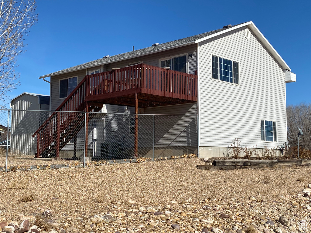 Back of house with a deck