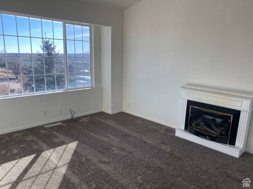 Unfurnished living room with dark colored carpet