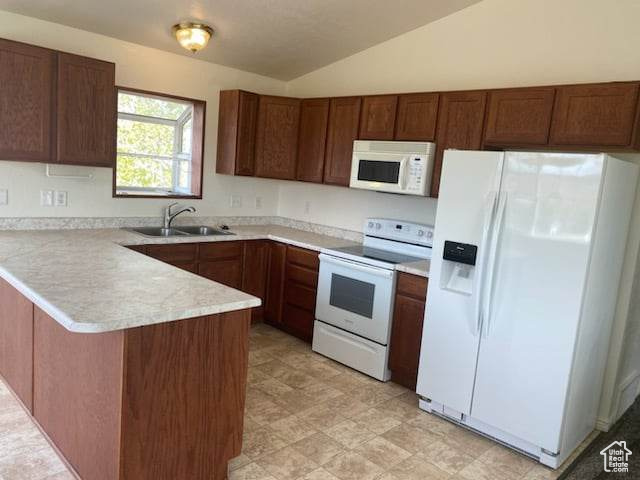 Kitchen with white appliances, light tile flooring, kitchen peninsula, vaulted ceiling, and sink