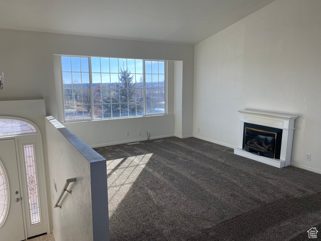 Unfurnished living room with dark colored carpet