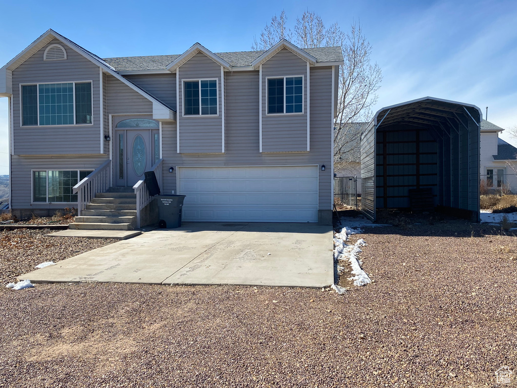 Split foyer home with a carport and a garage