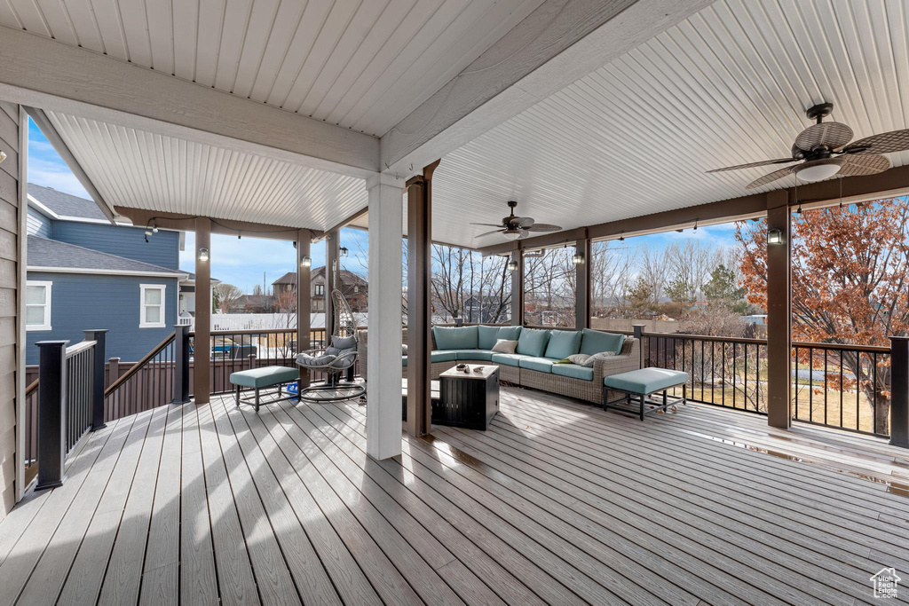 Wooden deck with ceiling fan and outdoor lounge area