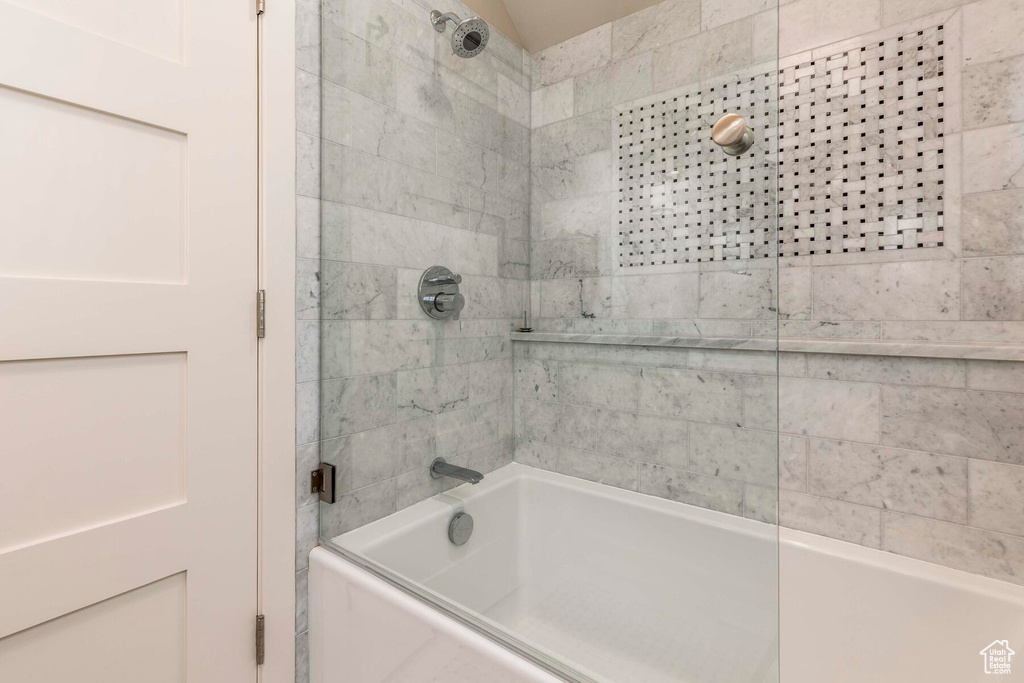 Bathroom with shower / bath combination with glass door