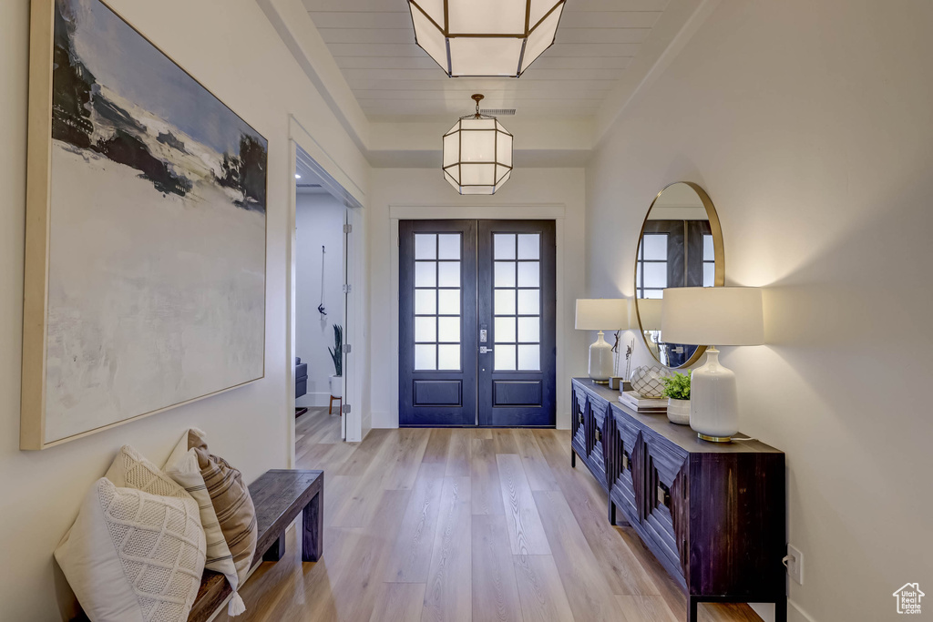 Foyer featuring light hardwood / wood-style flooring and french doors