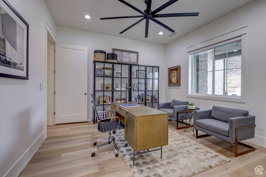 Home office featuring light hardwood / wood-style flooring and ceiling fan