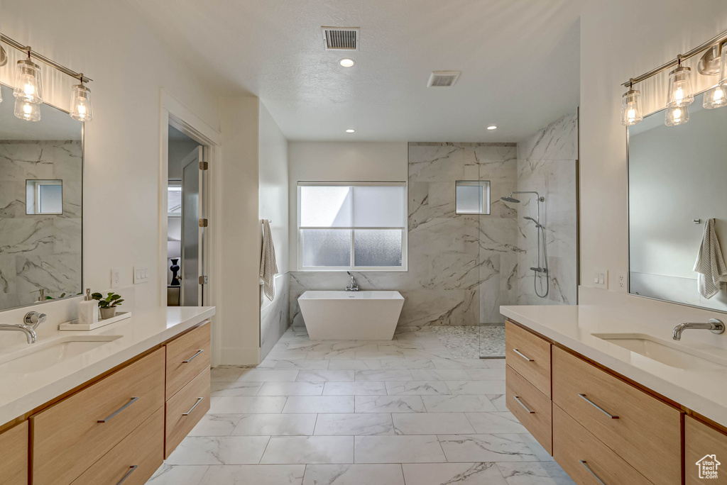 Bathroom featuring vanity, separate shower and tub, and tile flooring