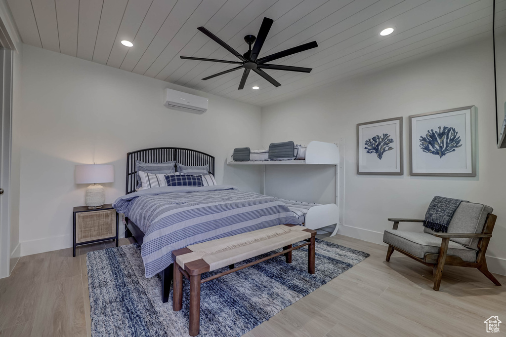 Bedroom featuring wood ceiling, light hardwood / wood-style floors, ceiling fan, and a wall unit AC