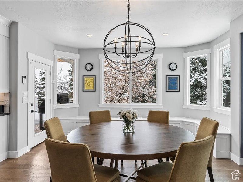 Dining room with a chandelier and hardwood / wood-style flooring