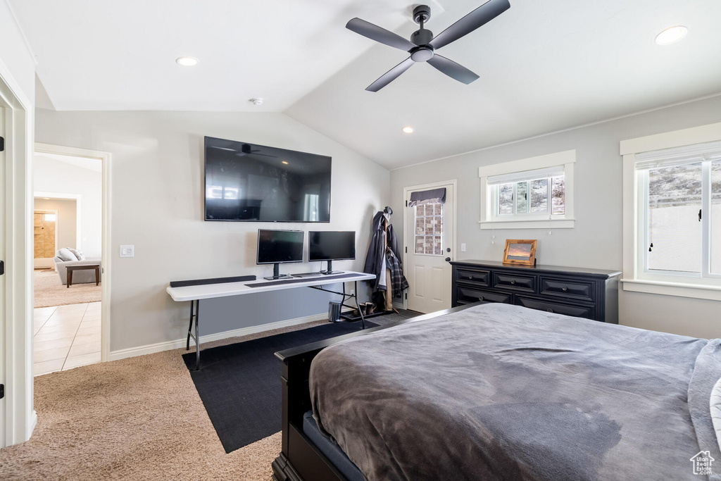 Bedroom featuring light tile flooring, ceiling fan, and lofted ceiling