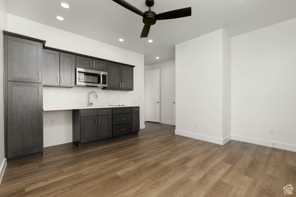 Kitchen with dark wood-type flooring and ceiling fan