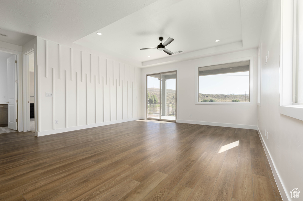 Spare room featuring ceiling fan and dark hardwood / wood-style floors