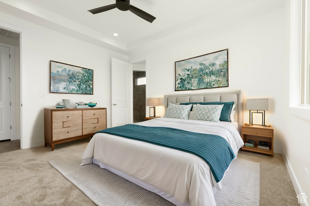 Carpeted bedroom featuring ceiling fan