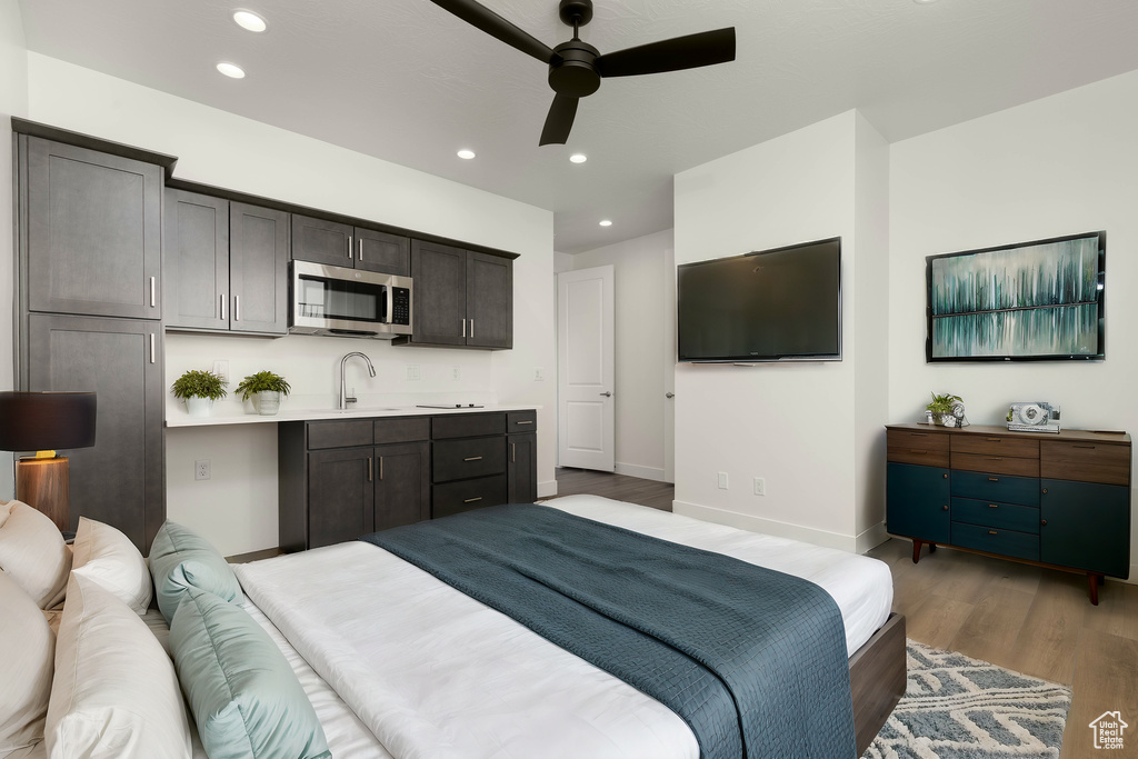 Bedroom with sink, dark hardwood / wood-style floors, and ceiling fan