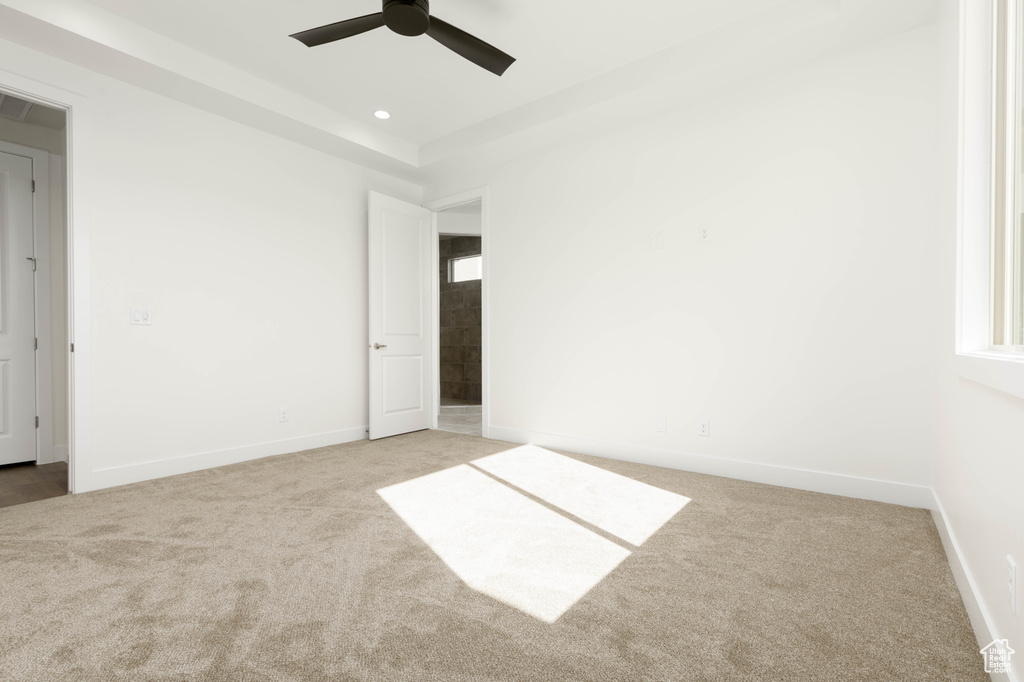 Unfurnished bedroom with light carpet and ceiling fan