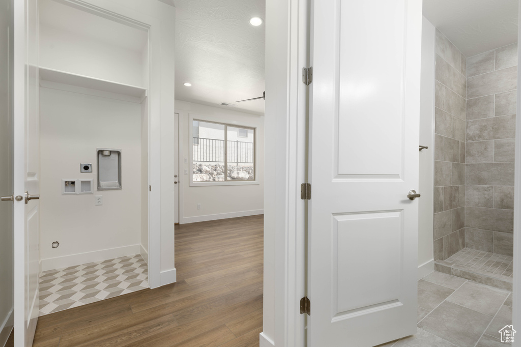 Bathroom featuring tiled shower and hardwood / wood-style flooring