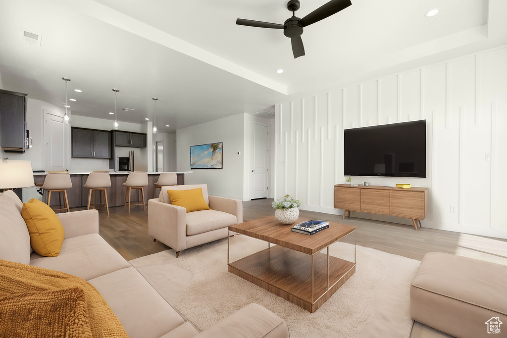 Living room with light wood-type flooring and ceiling fan