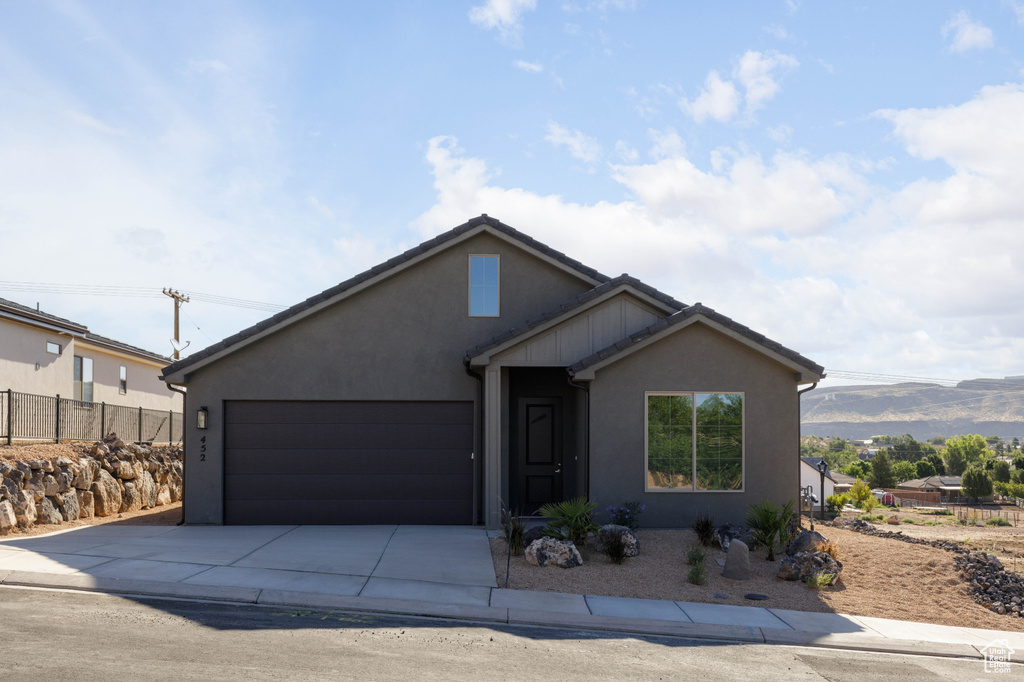 View of front of property featuring a mountain view and a garage