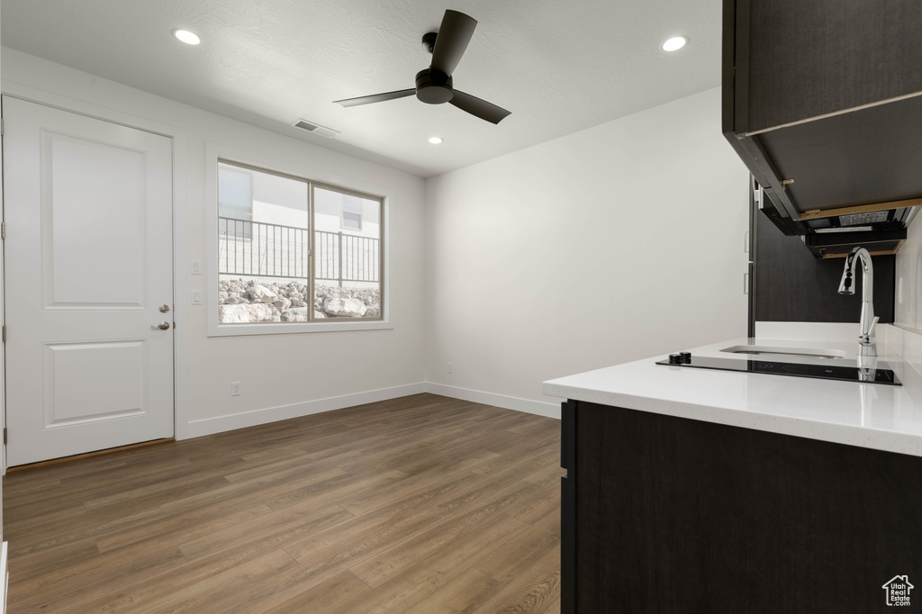 Kitchen featuring ceiling fan, sink, and hardwood / wood-style flooring