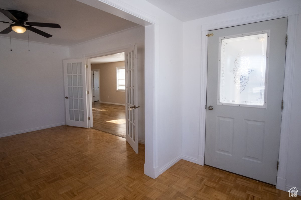 Entryway featuring ceiling fan and light parquet floors