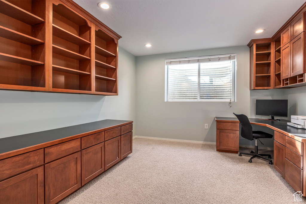 Carpeted office space with built in desk