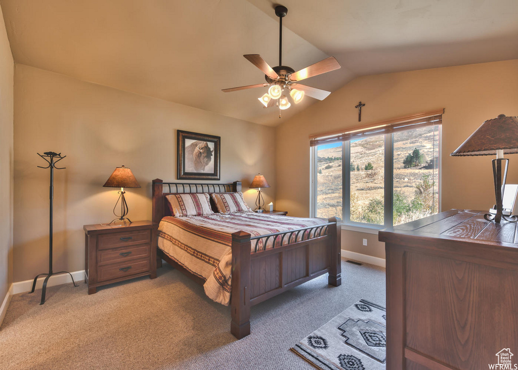 Bedroom featuring ceiling fan, light colored carpet, and vaulted ceiling