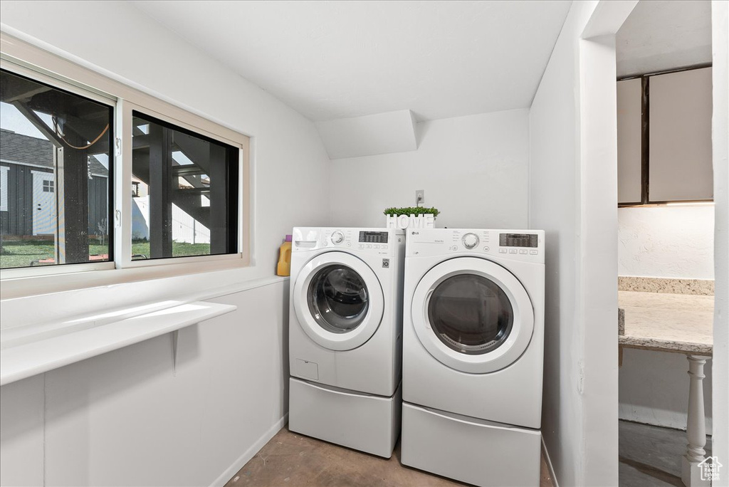 Laundry room with tile floors and independent washer and dryer