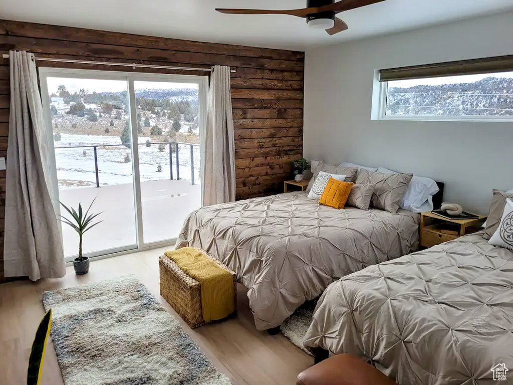 Bedroom featuring light hardwood / wood-style flooring, access to exterior, and ceiling fan