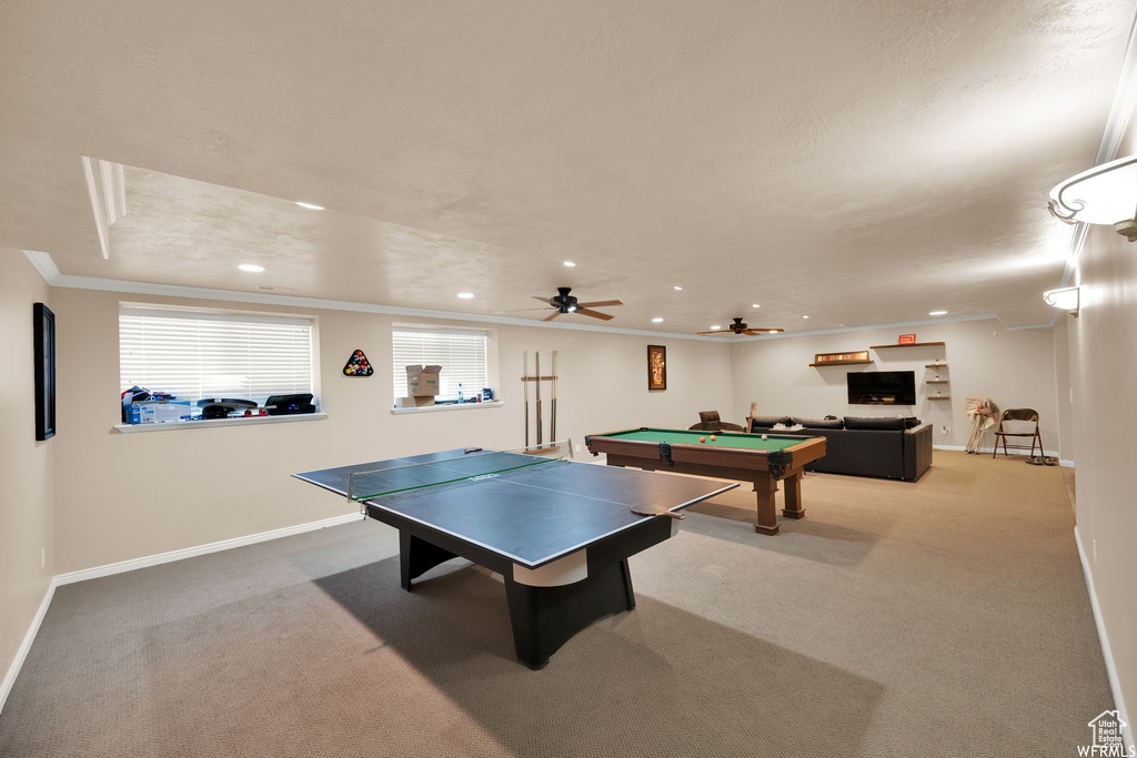 Recreation room featuring carpet floors, crown molding, billiards, and ceiling fan