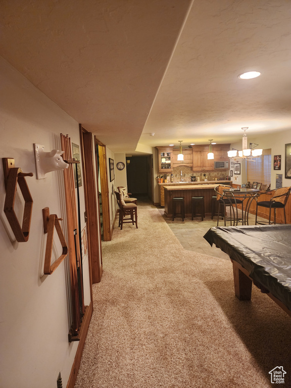 Recreation room with bar area, light carpet, and billiards