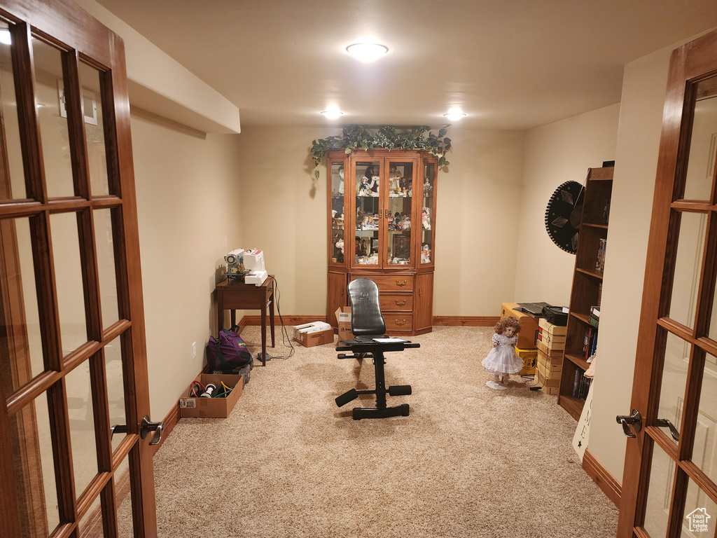 Exercise area with light carpet and french doors
