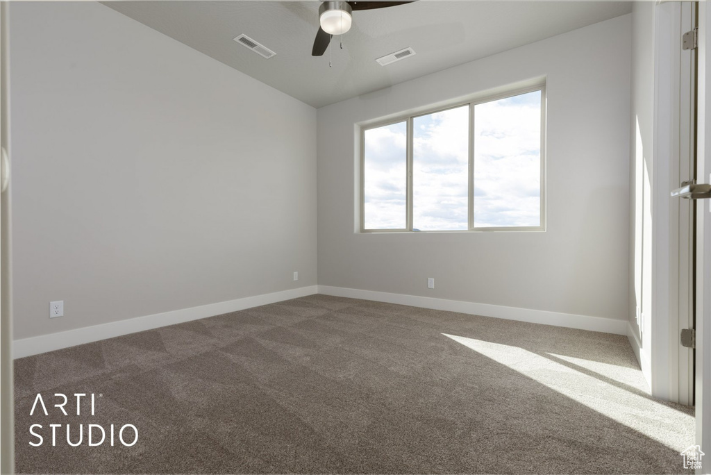 Carpeted spare room with ceiling fan