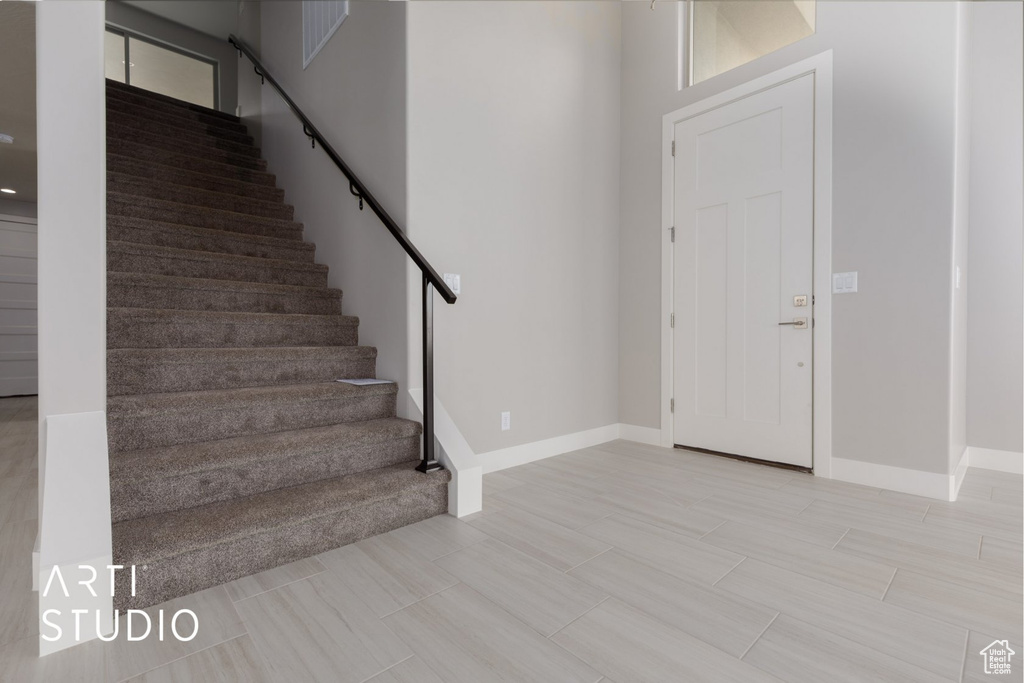 Foyer entrance featuring light tile floors