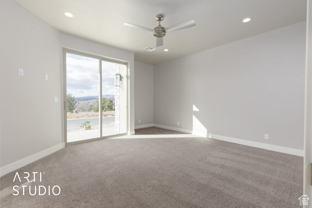 Unfurnished room with ceiling fan and light colored carpet