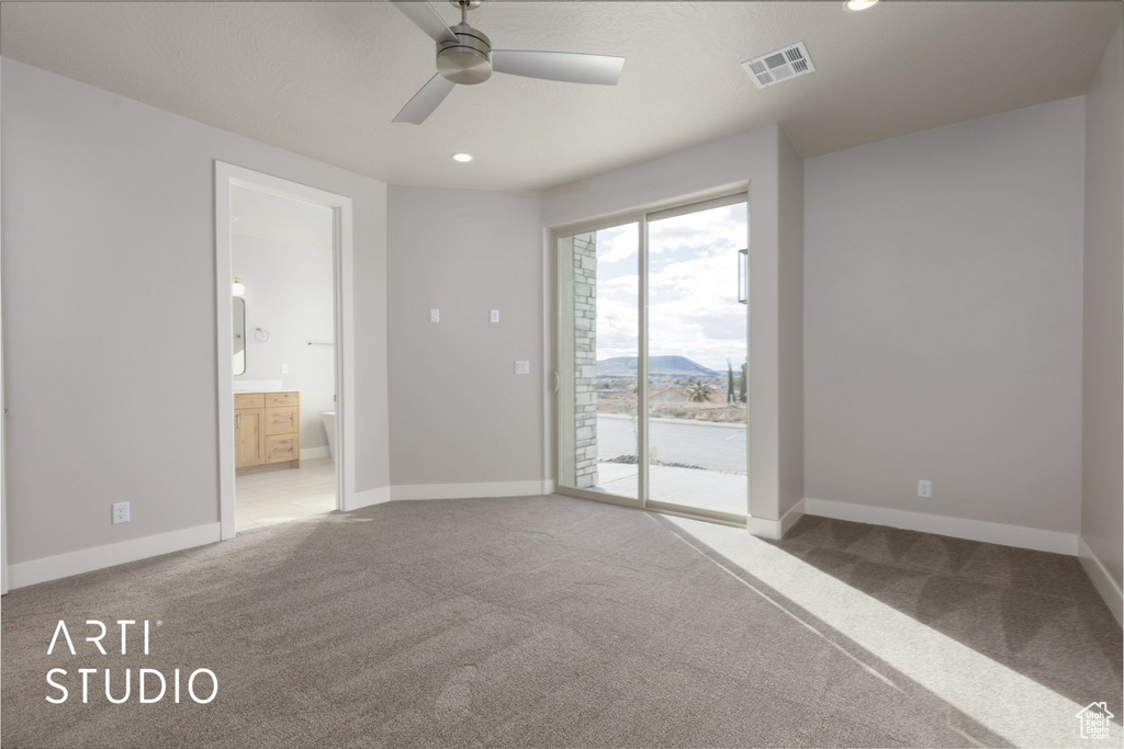 Empty room with dark colored carpet and ceiling fan