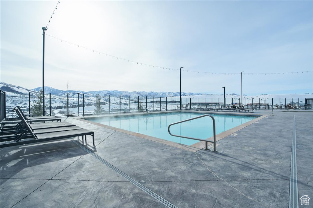 View of pool featuring a mountain view and a patio