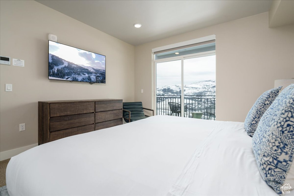 Bedroom with a mountain view, carpet floors, and access to exterior