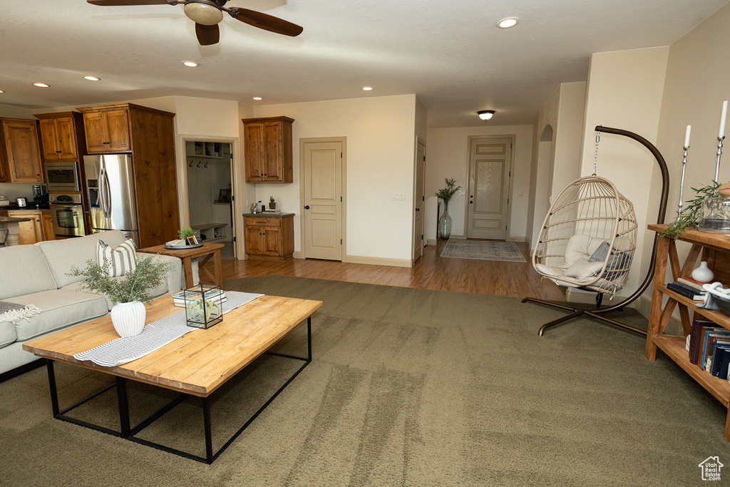 Living room featuring ceiling fan and carpet flooring
