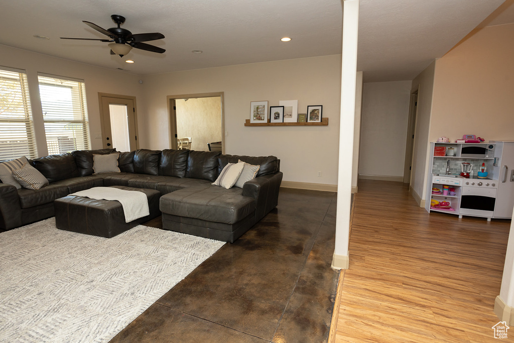 Living room with ceiling fan and wood-type flooring