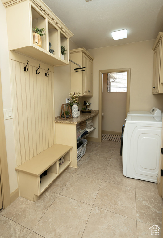 Mudroom with light tile flooring and washer and clothes dryer