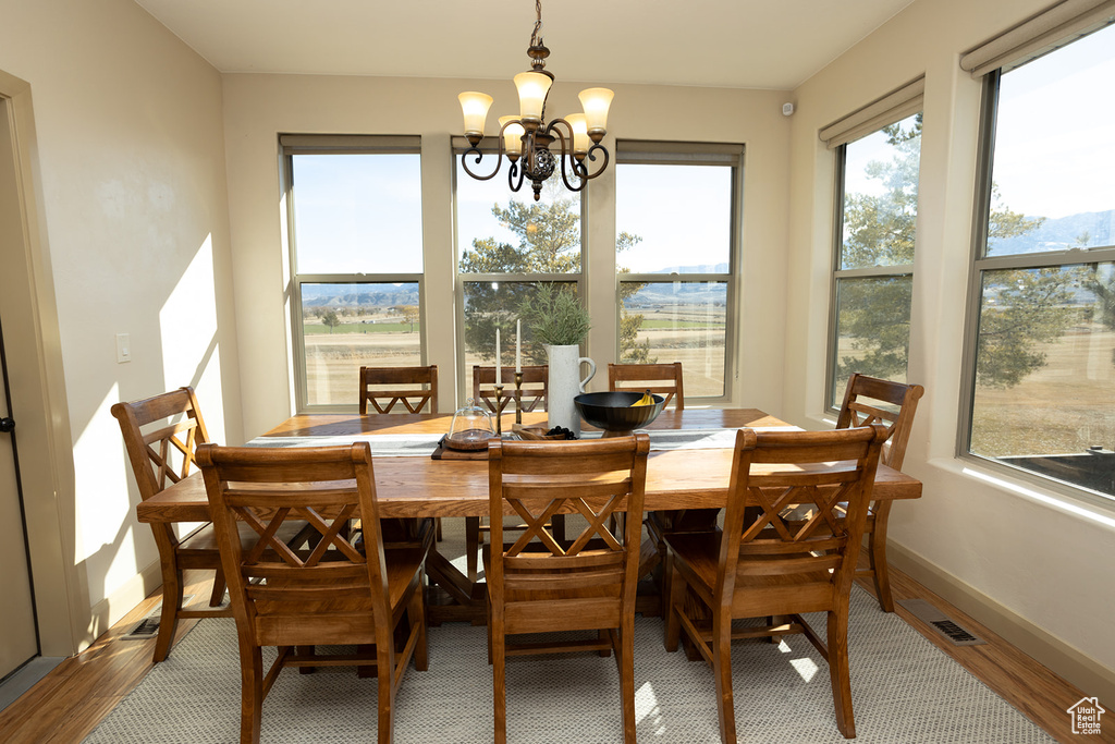Dining space featuring hardwood / wood-style flooring and a notable chandelier