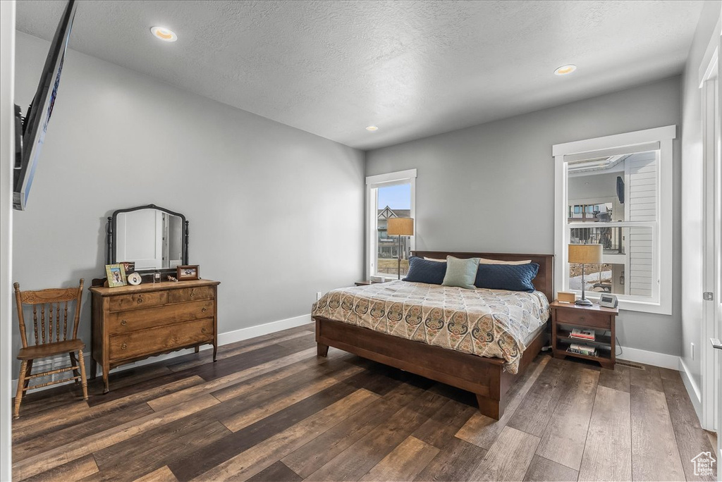 Bedroom featuring dark wood-type flooring and a textured ceiling