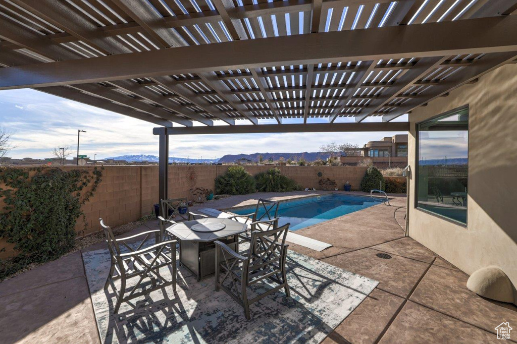 View of patio / terrace featuring a mountain view, a fenced in pool, and a pergola
