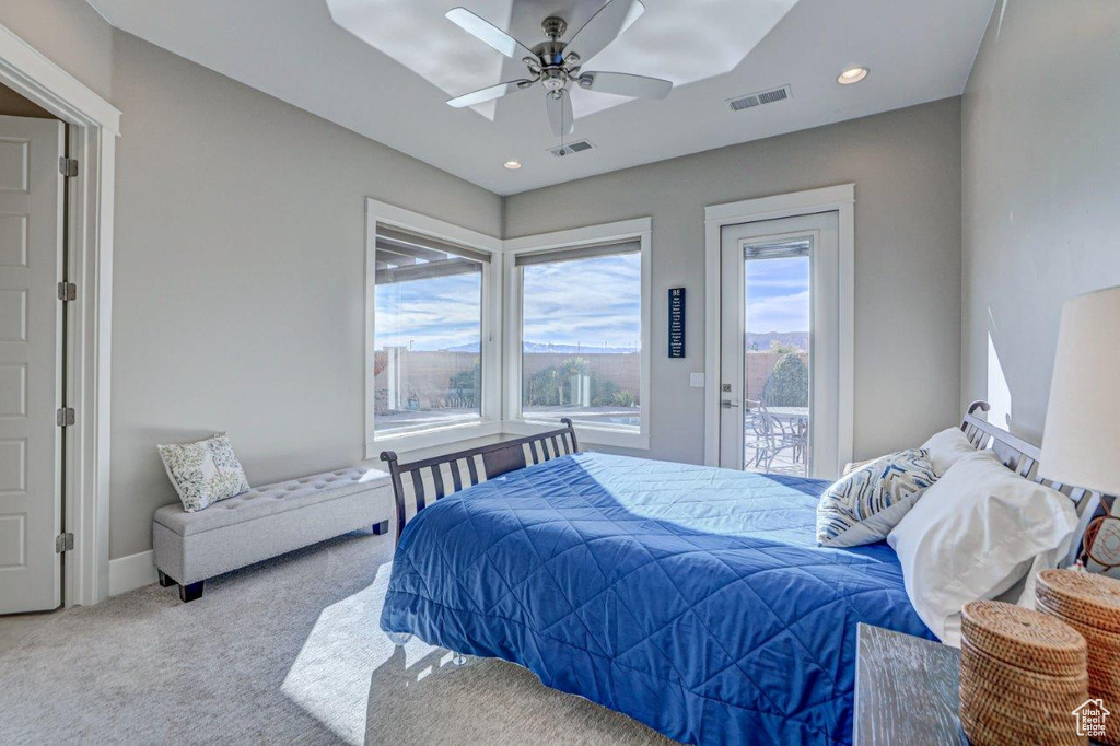 Bedroom featuring light colored carpet, ceiling fan, and access to outside